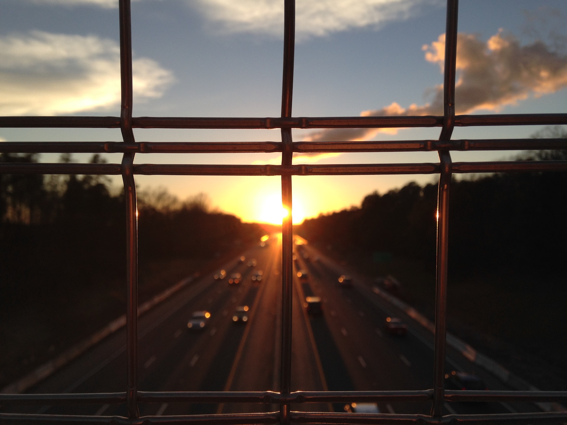 Commuters driving on highway during sunset.